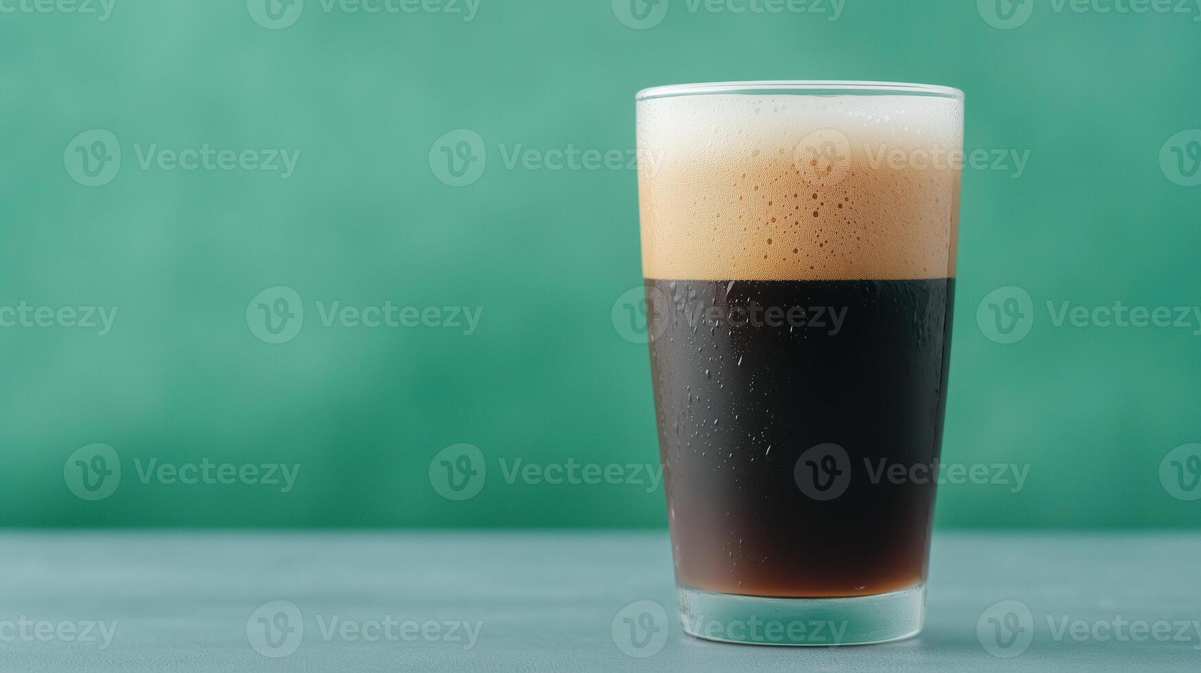 Refreshing Dark Beer with Bubbles in a Tall Glass Against a Green Backdrop Perfect for Celebrating Oktoberfest or Enjoying Craft Brew Tastings photo