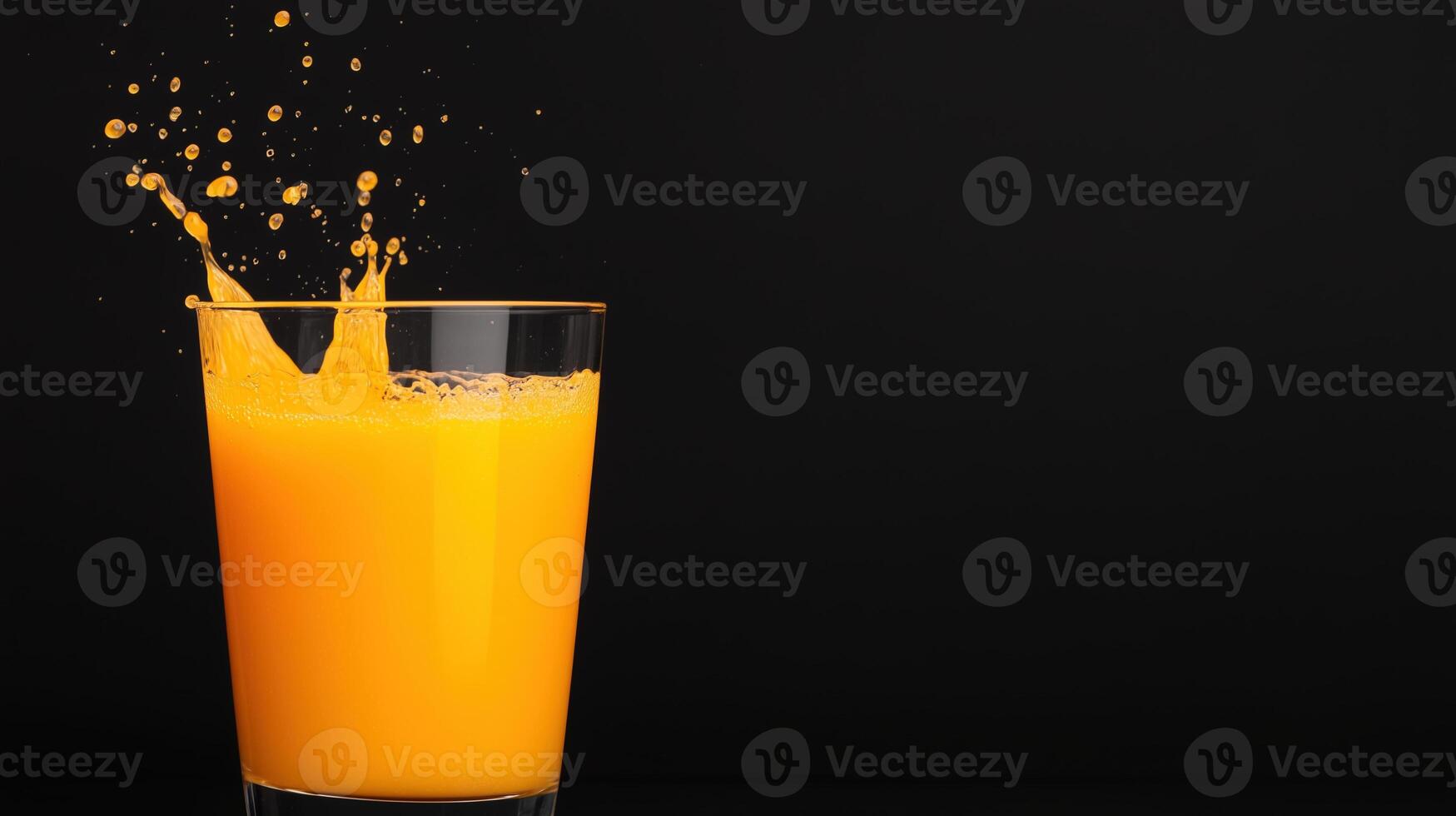 Fresh Orange Juice Splashing in Glass Against Black Background Capturing Vibrant Citrus Explosion in Slow Motion for Refreshing Beverage Advertising and Healthy Lifestyle Campaign photo