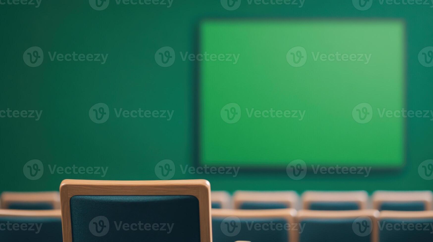 Green Screen Stage Setup at Charity Fundraiser Event with Chairs in Focus, Ideal for Production, Presentations, and Media Backgrounds in Modern Conference and Event Spaces photo