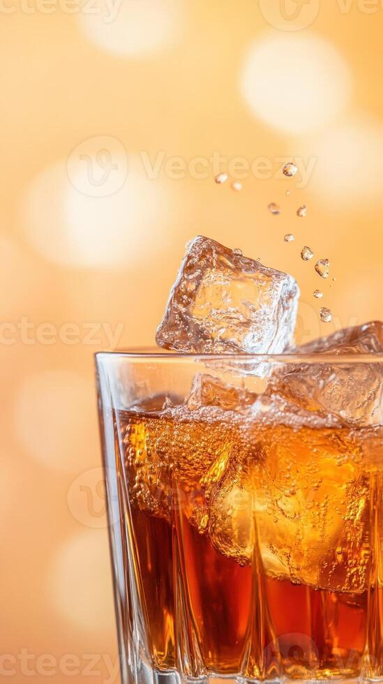 Slow Motion Macro of Ice Cubes Falling into Whiskey Glass with Golden Bokeh Background for Refreshing Drink Concept photo