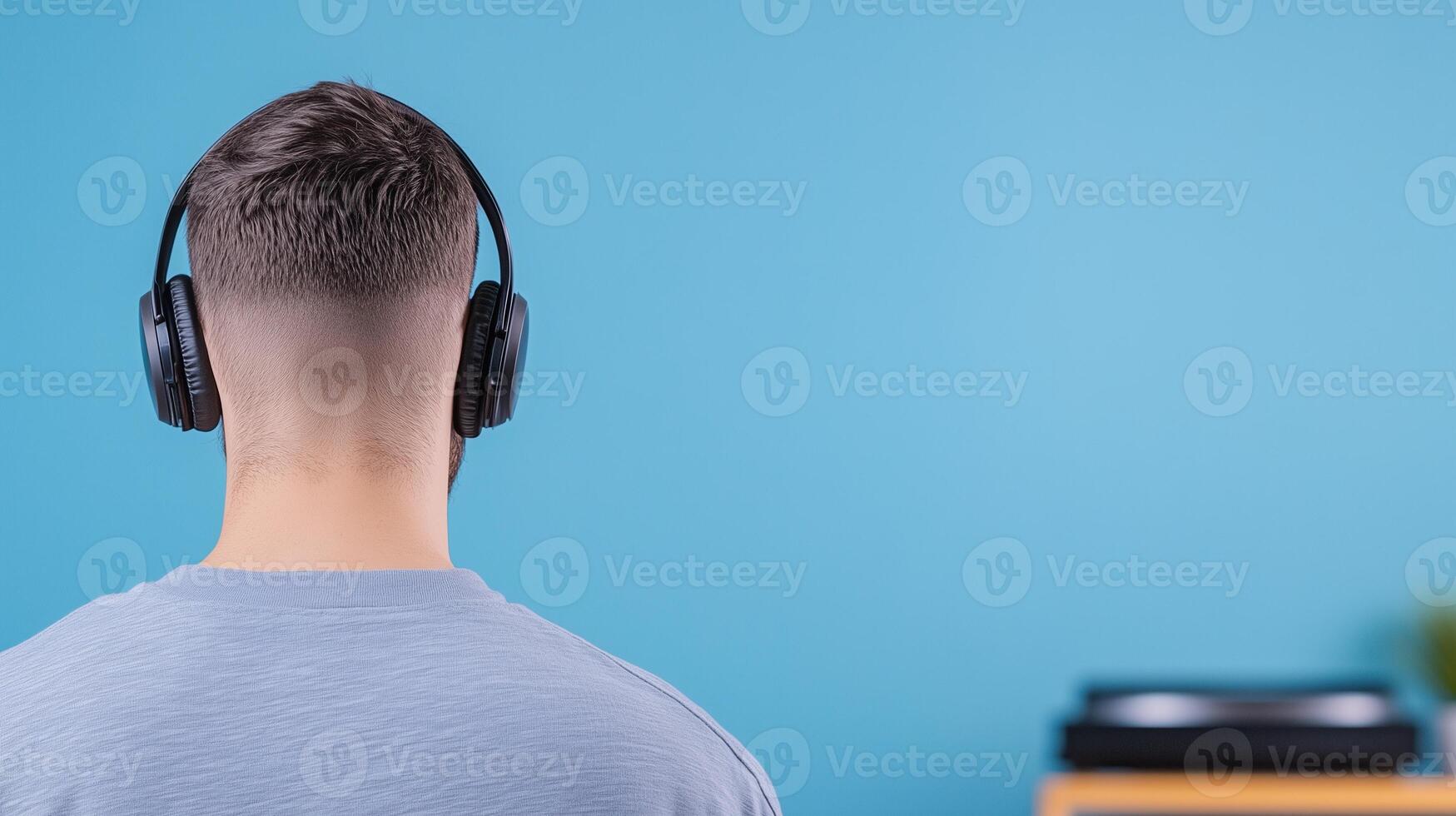 Music Enthusiast Enjoying Vinyl Records in Cozy Modern Room with Headphones in AR 169 Aspect Ratio Reflecting Contemporary Style and Relaxation Vibes in Blue Background Interior Scene photo