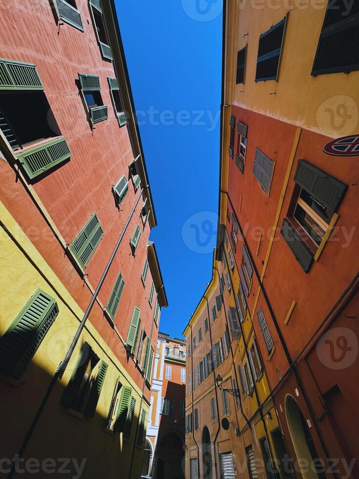 Vibrant Colorful Alleyway Located Under A Clear Blue Sky Filled With Bright Sunshine photo
