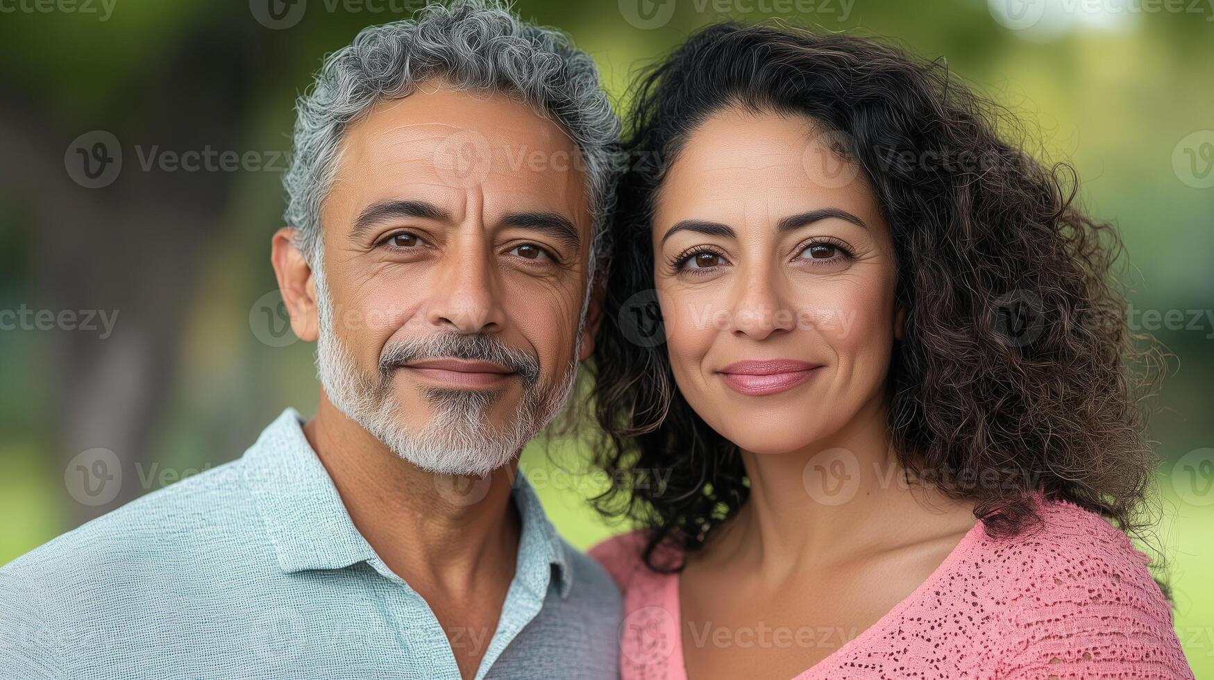 Mature Hispanic Couple Smiling at Family Gathering Outdoors in Natural Light, Reflecting Warmth, Connection, and Happiness in a Lush Green Park Setting, Highlighting Relationship and Togetherness photo