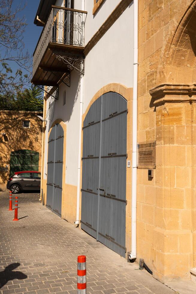 A quiet and hidden lane in the historic part of the Cypriot town of Nicosia,and unrecognizable woman with her back,Nicosia,Cyprus November 4,2023 photo