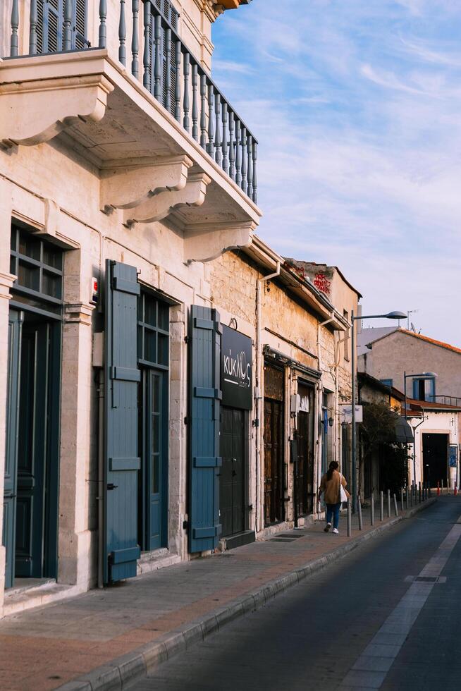 A quiet and hidden lane in the historic part of the Cypriot town of Nicosia,and unrecognizable woman with her back,Nicosia,Cyprus November 4,2023 photo