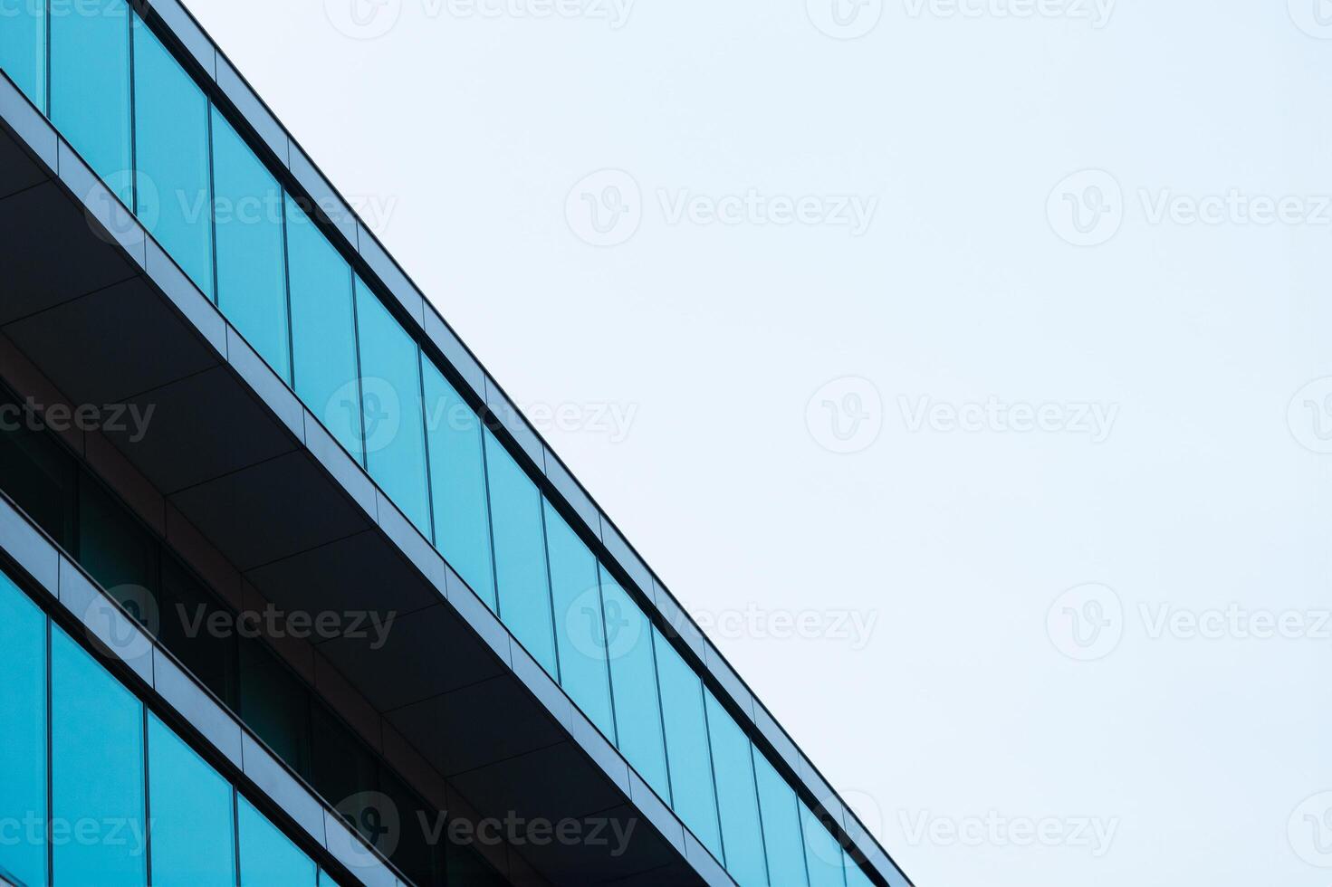 New blue glass building architecture on blue sky background,Low angle architectural exterior view of modern, copy space for text photo