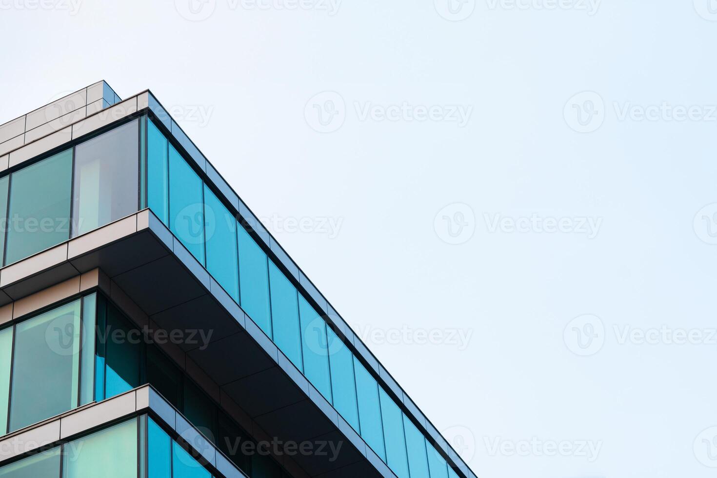 New blue glass building architecture on blue sky background,Low angle architectural exterior view of modern, copy space for text photo