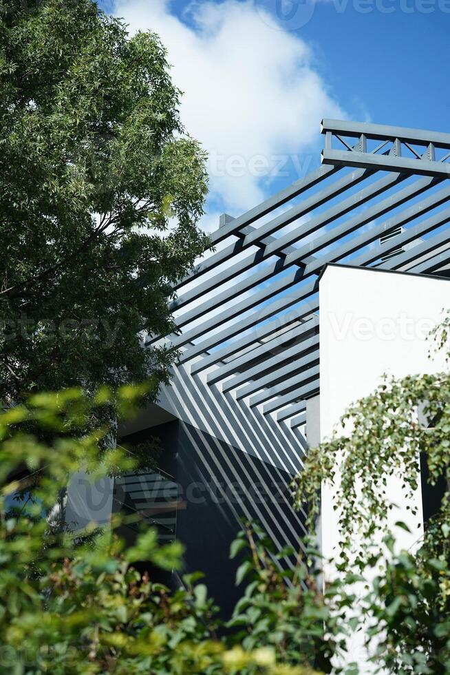 Modern east style building with beige walls and rail sunlight shadows. Abstract architecture facade design concept background photo