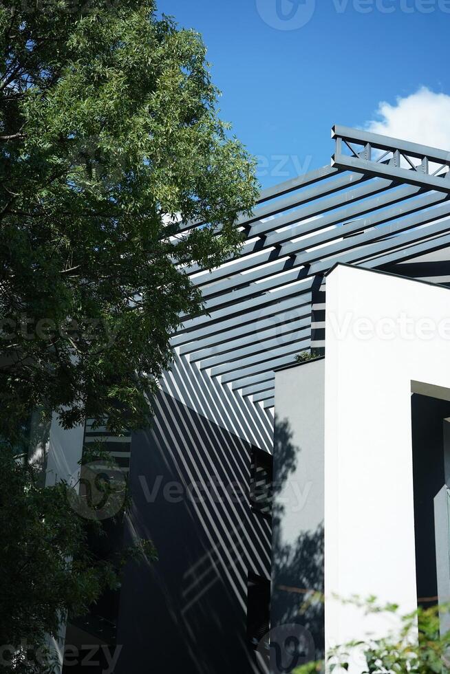 Modern east style building with beige walls and rail sunlight shadows. Abstract architecture facade design concept background photo
