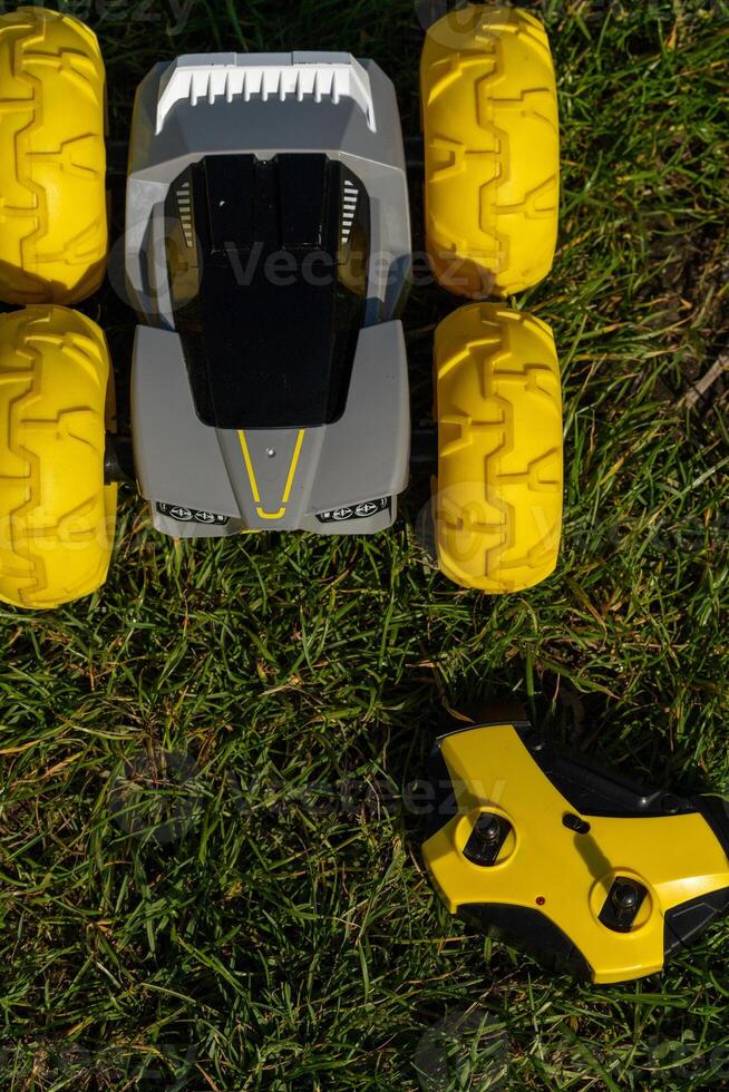 yellow jeep with remote control toy on green grass photo