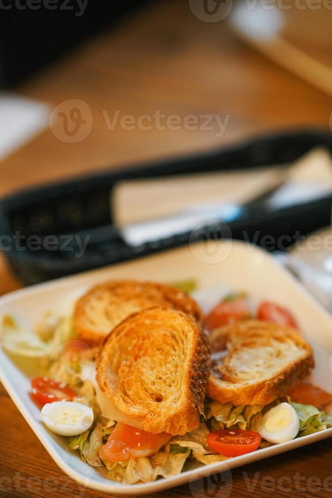 Caesar chicken salad with grated parmesan on white table photo