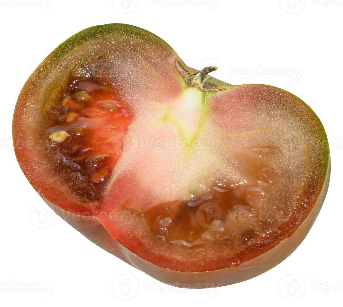 Half ripe tomato of the Kumato variety with dark green and brownish glossy skin on an isolated background photo