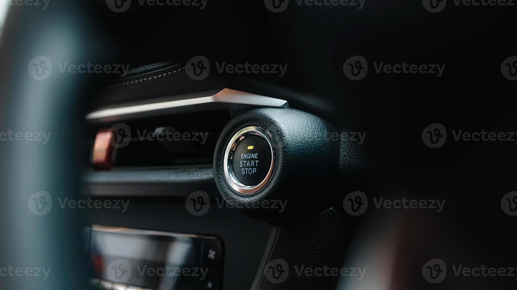 Close-up of a car start button. Concept of modern technology, convenience, and innovation in cars. Dashboard with focus on engine start stop button, car interior details. Banner, free copy space photo
