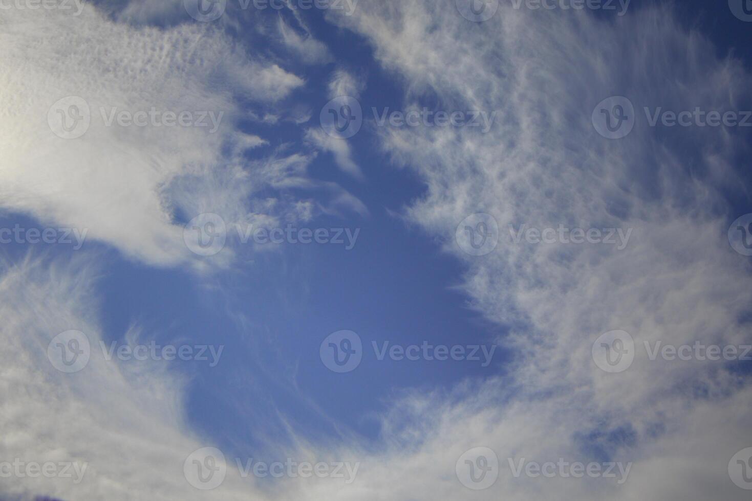 Swirling Cirrus Clouds Forming a Dramatic Pattern in the Sky photo