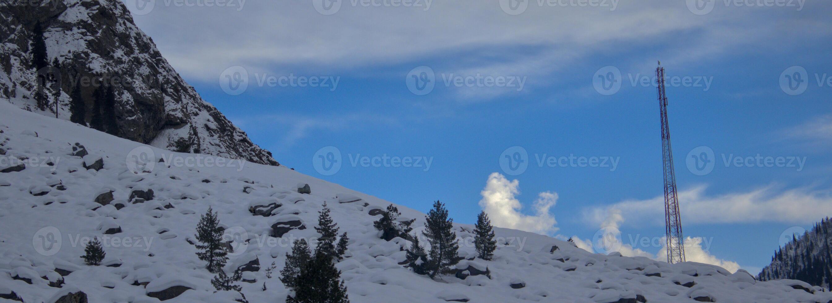 Winter Landscape with Snow-Covered Hills and Communication Tower photo