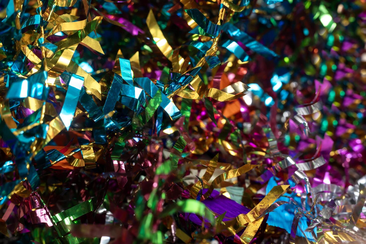 Colorful festive tinsel backdrop in a bright decorative arrangement. Perfect for celebrations, parties, events or holiday decorations. photo