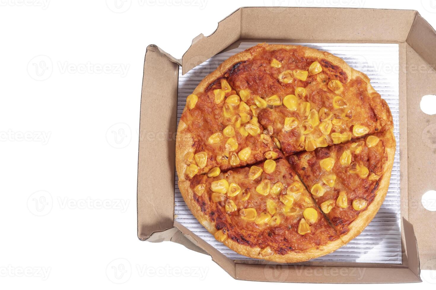 Delicious corn topping pizza in open cardboard box for delivery or takeaway photo