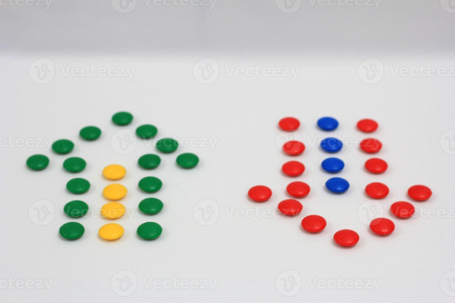 Up and down arrows created with colorful candy dots on a white background, representing direction, choice, and balance photo