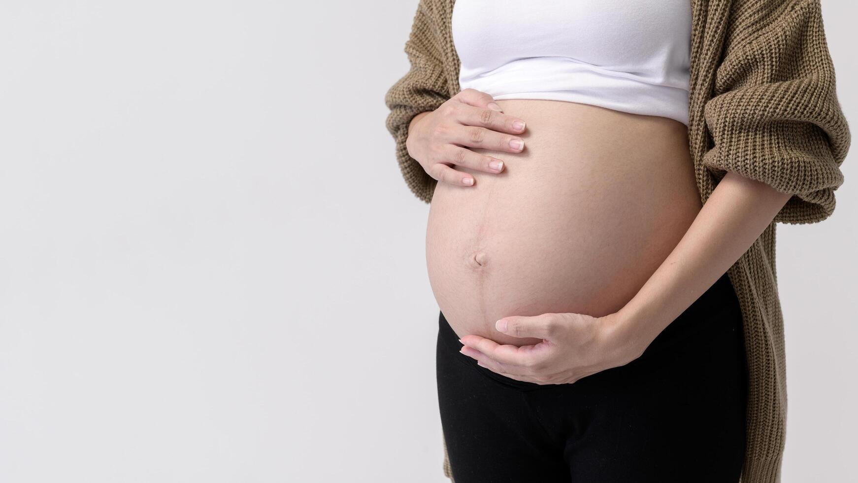 Portrait of Beautiful pregnant woman on white background photo