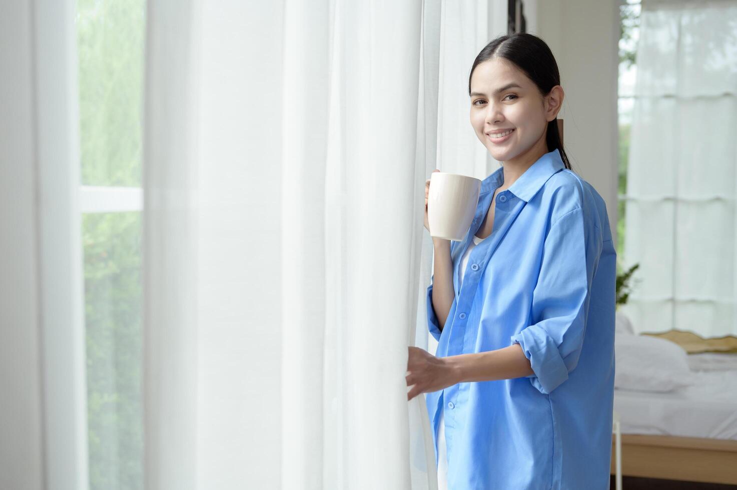 Morning Routine in a Bright Bedroom With a Woman Enjoying Coffee by the Window photo