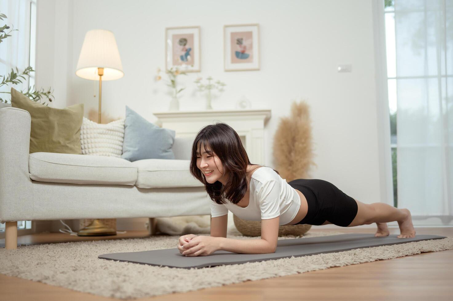 Woman Practicing Plank Exercise in Cozy Living Room Environment During Daytime photo