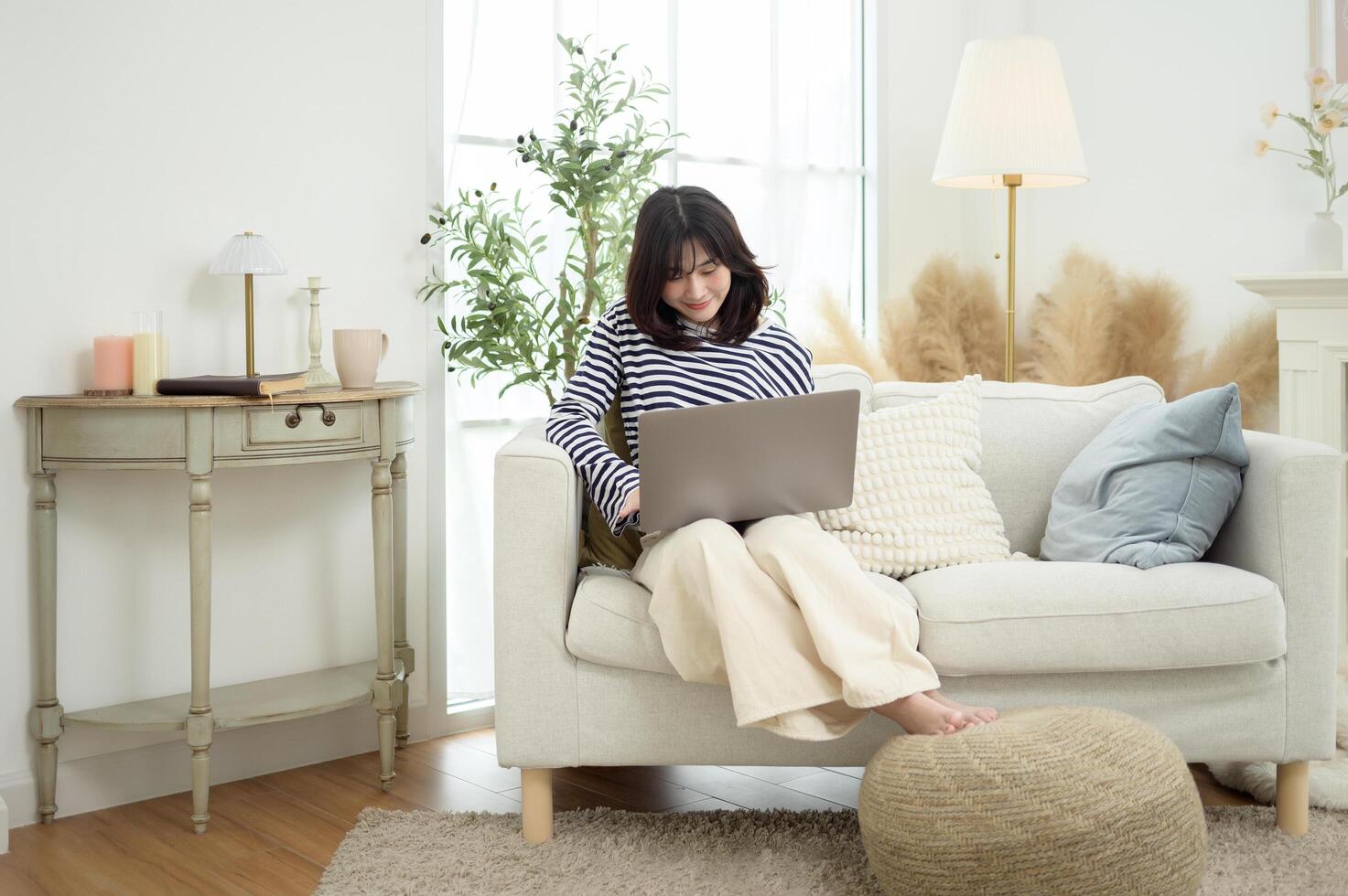 Woman Working on Laptop in a Bright and Cozy Living Room photo