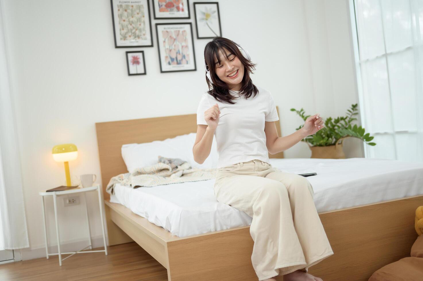 Enjoying a Joyful Moment in a Bright, Modern Bedroom During the Daytime photo