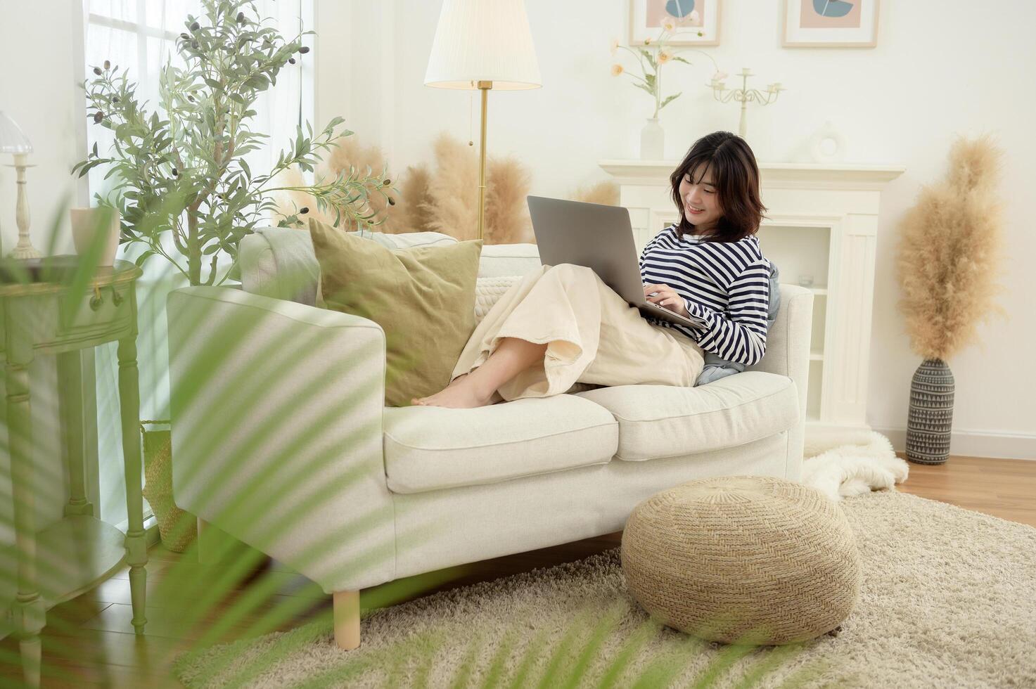 Woman Working on Laptop in a Bright and Cozy Living Room photo