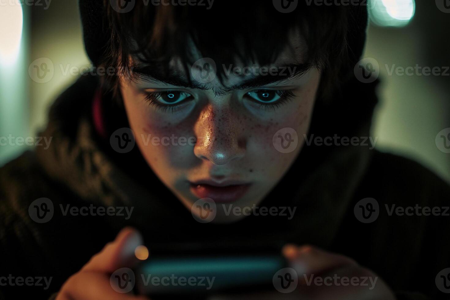 Close Up of Little Boy Focused on Smartphone photo