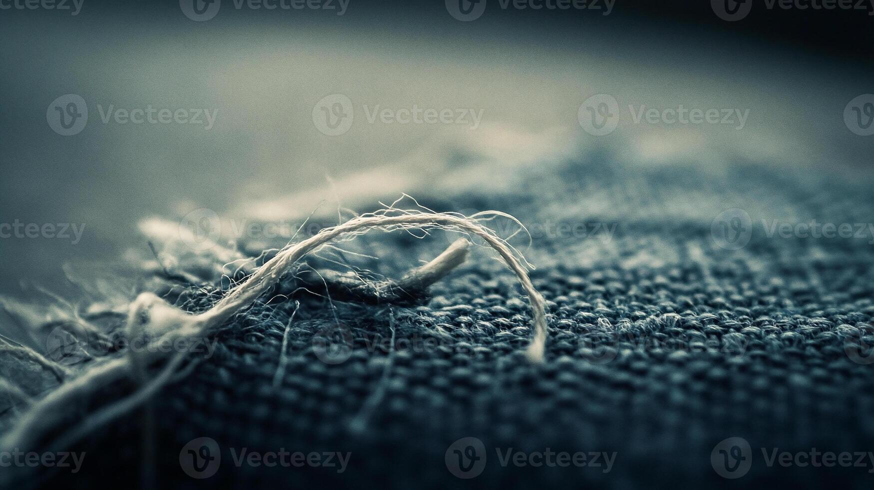 Single Thread Unraveling from Linen Cloth Close Up photo