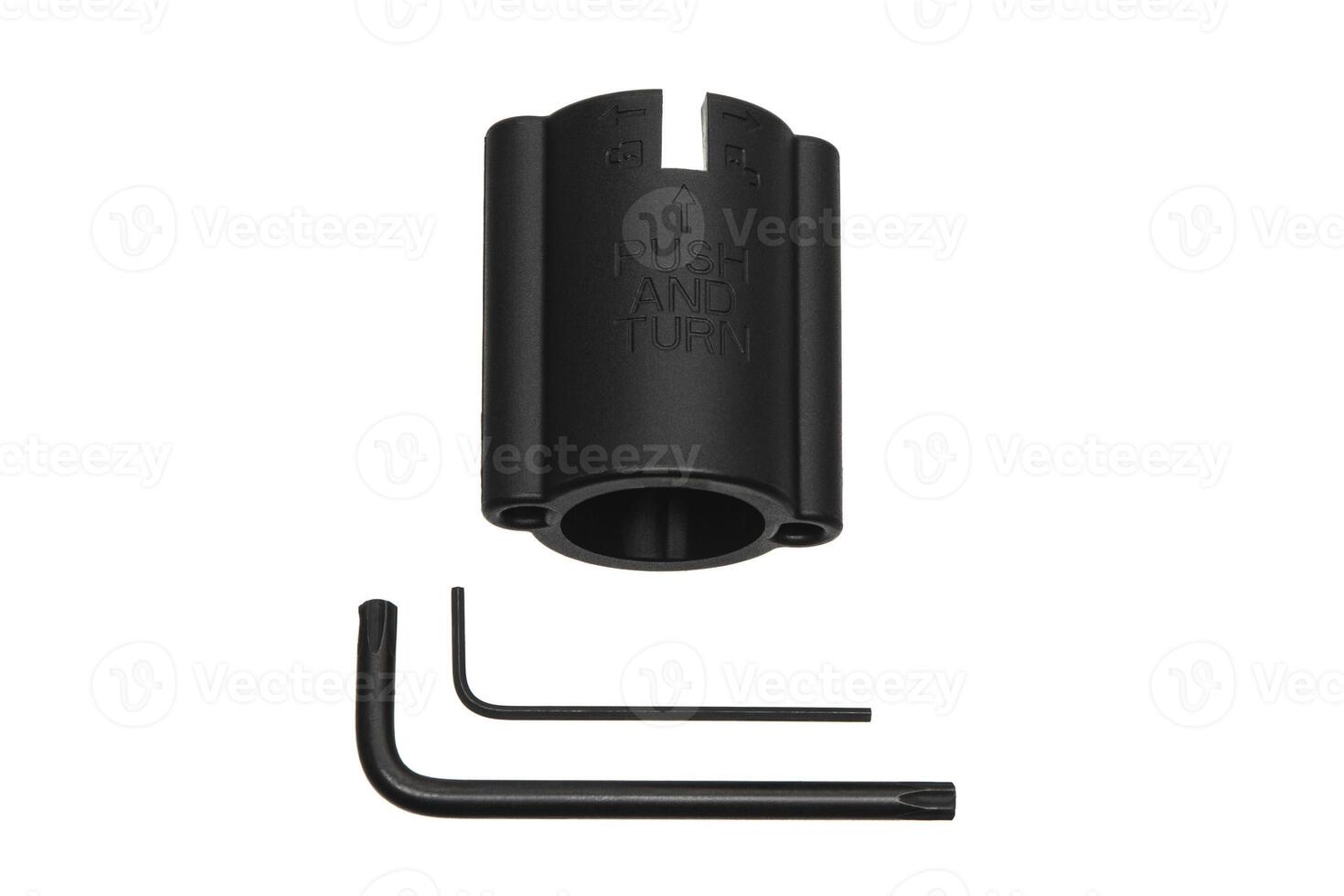 Black plastic tool with 'PUSH AND TURN' text, two L-shaped hex keys, isolated on white background. photo