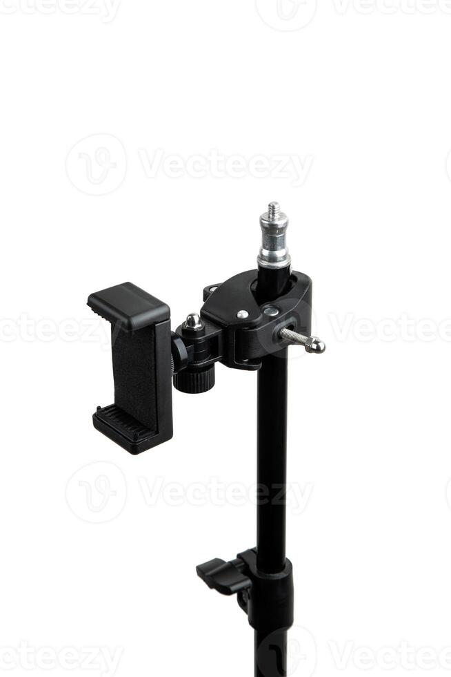 A black tripod stand with an adjustable clamp holder, suitable for holding devices like smartphones or cameras, isolated on a white back photo