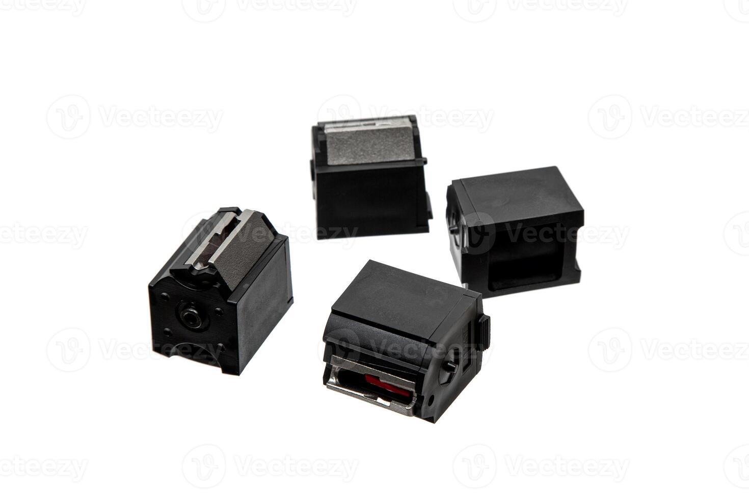 Four black .22lr rifle magazines arranged on a white background photo