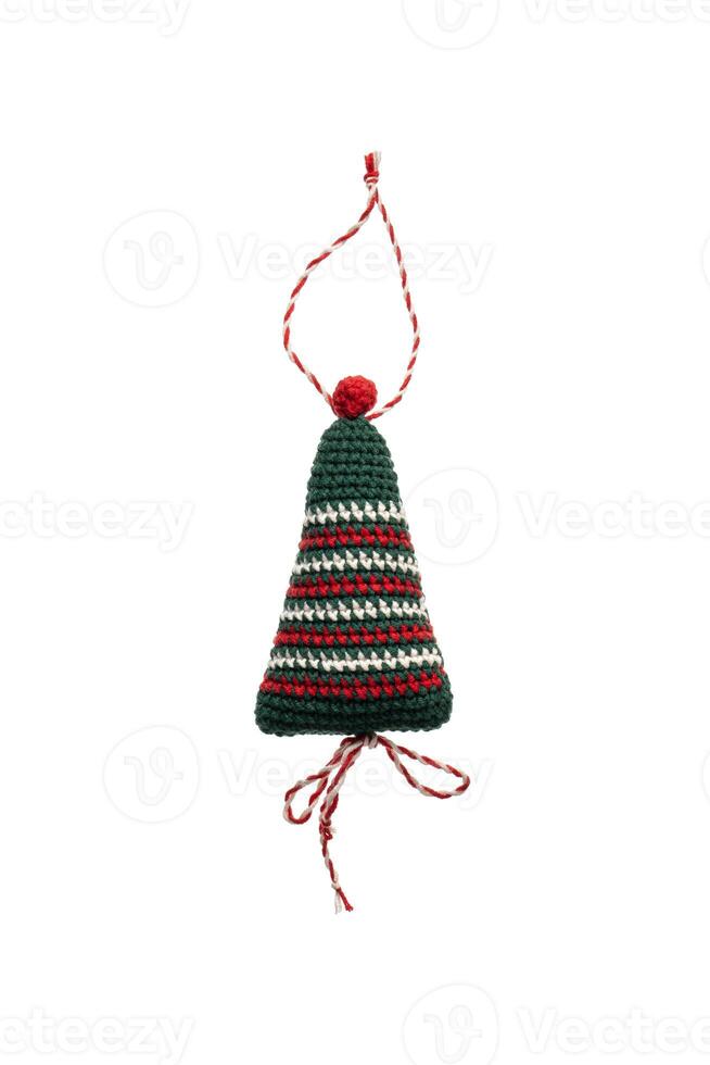 A handmade crochet Christmas tree ornament with red, green, and white stripes, featuring a red pom-pom on top and a twisted red and white hanging loop, isolated on a white back photo