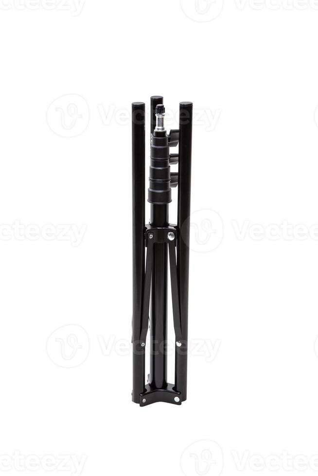 A folded black tripod stand isolated on a white background, compact and portable. photo
