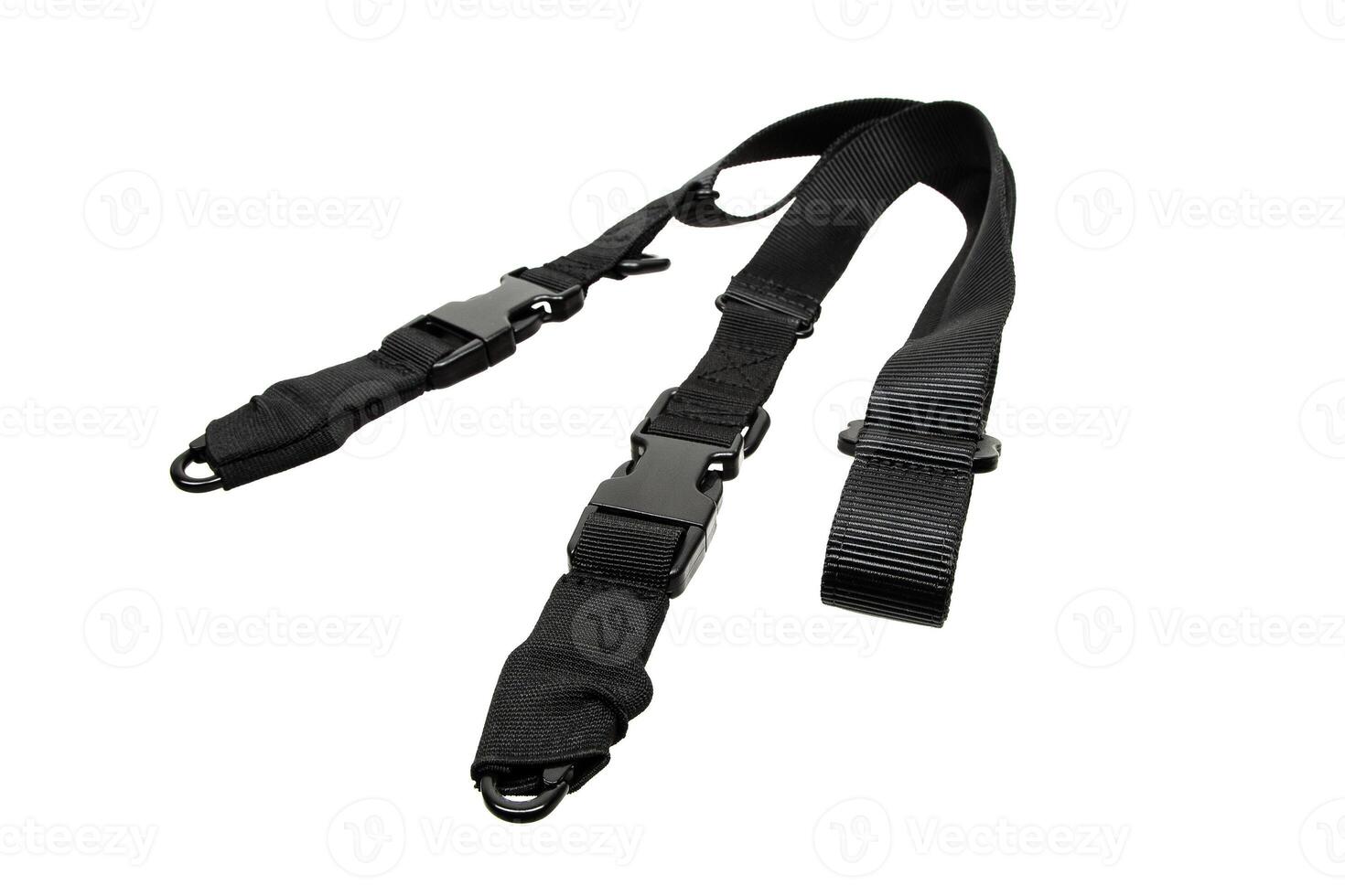 Black adjustable shoulder strap with quick-release buckles and D-rings, suitable for bags or gear, isolated on white back. photo