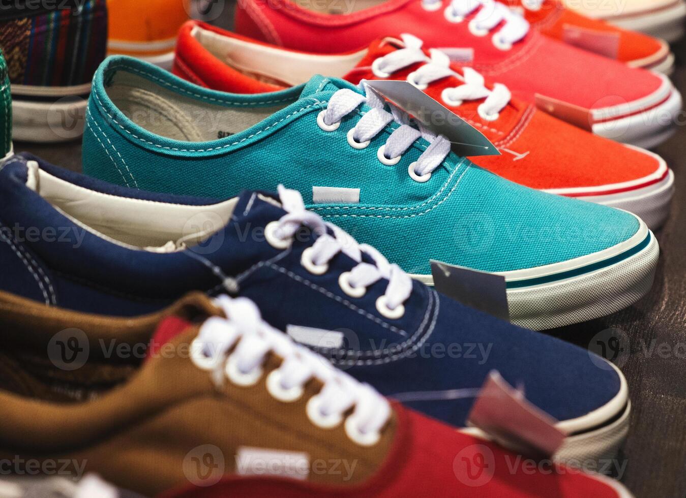 A variety of colorful canvas sneakers are displayed in a store, showcasing different styles and vibrant colors. photo