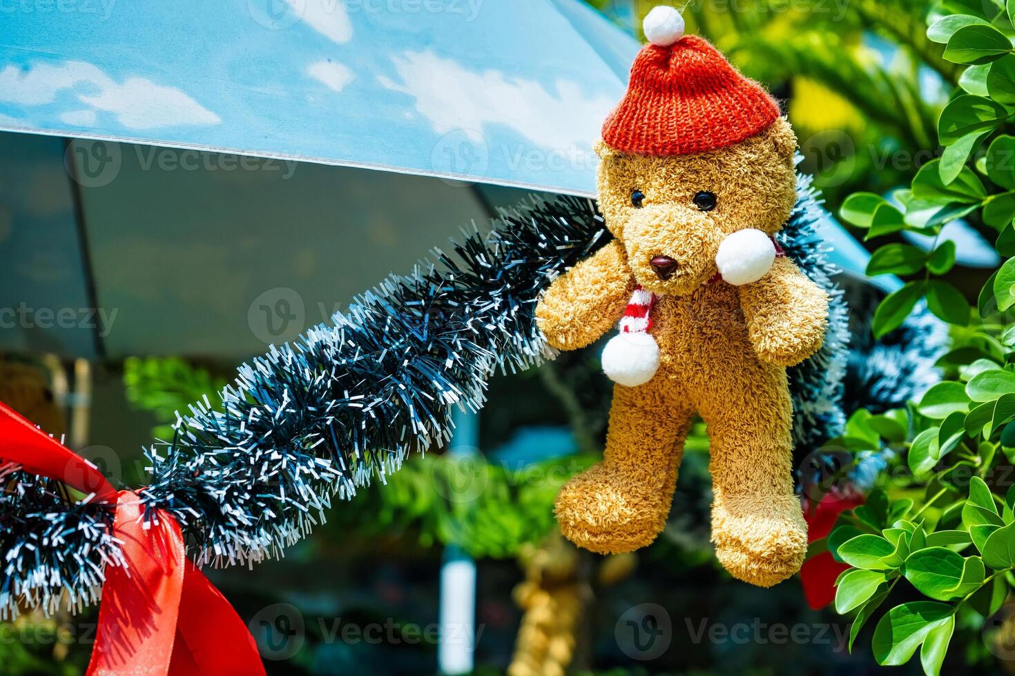 Christmas Tree Ornament with a Cute Brown Teddy Bear and Golden Holiday Decorations photo