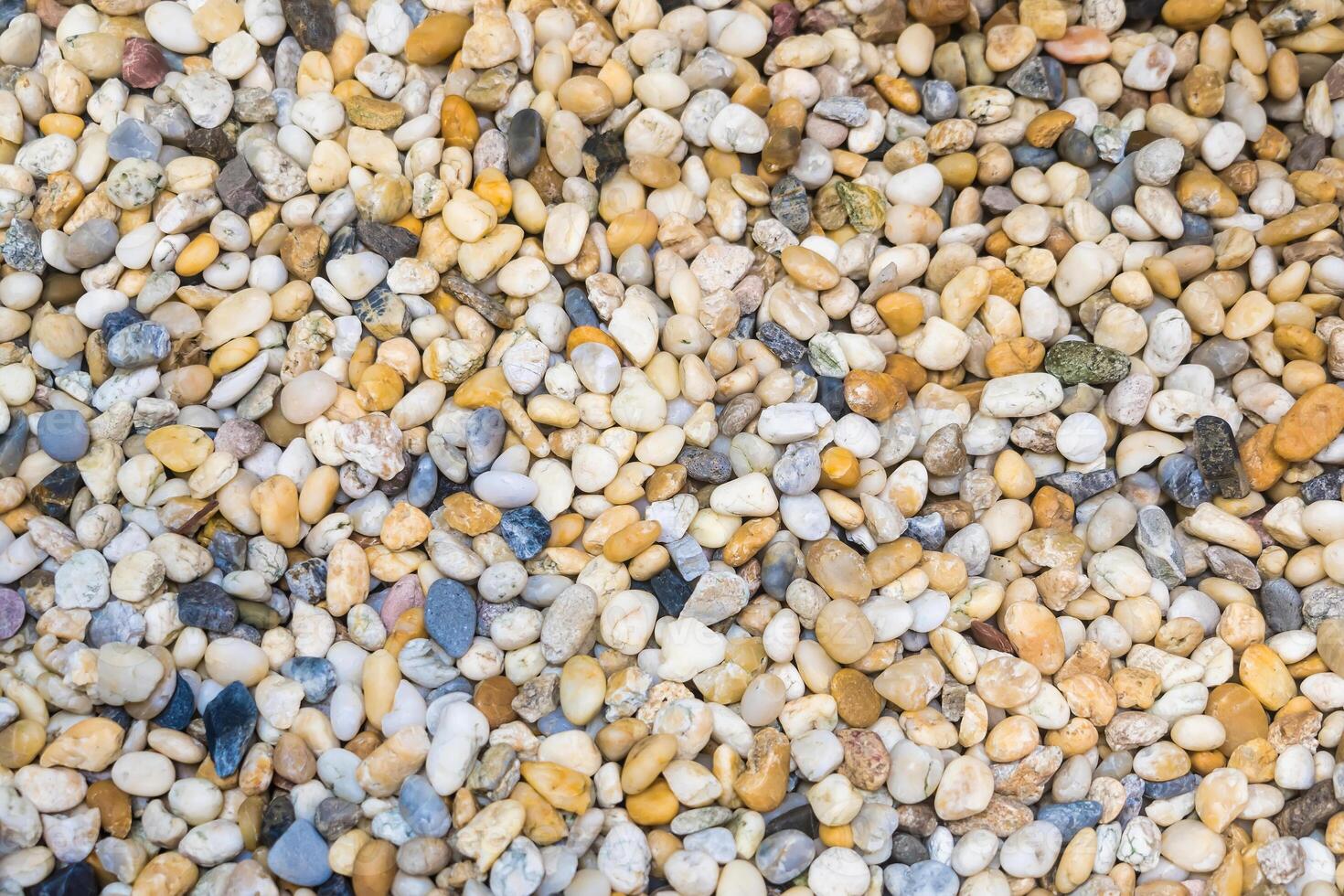 Colorful River Pebbles Background.A Vibrant Collection of Smooth Stones in Various Shades and Sizes photo