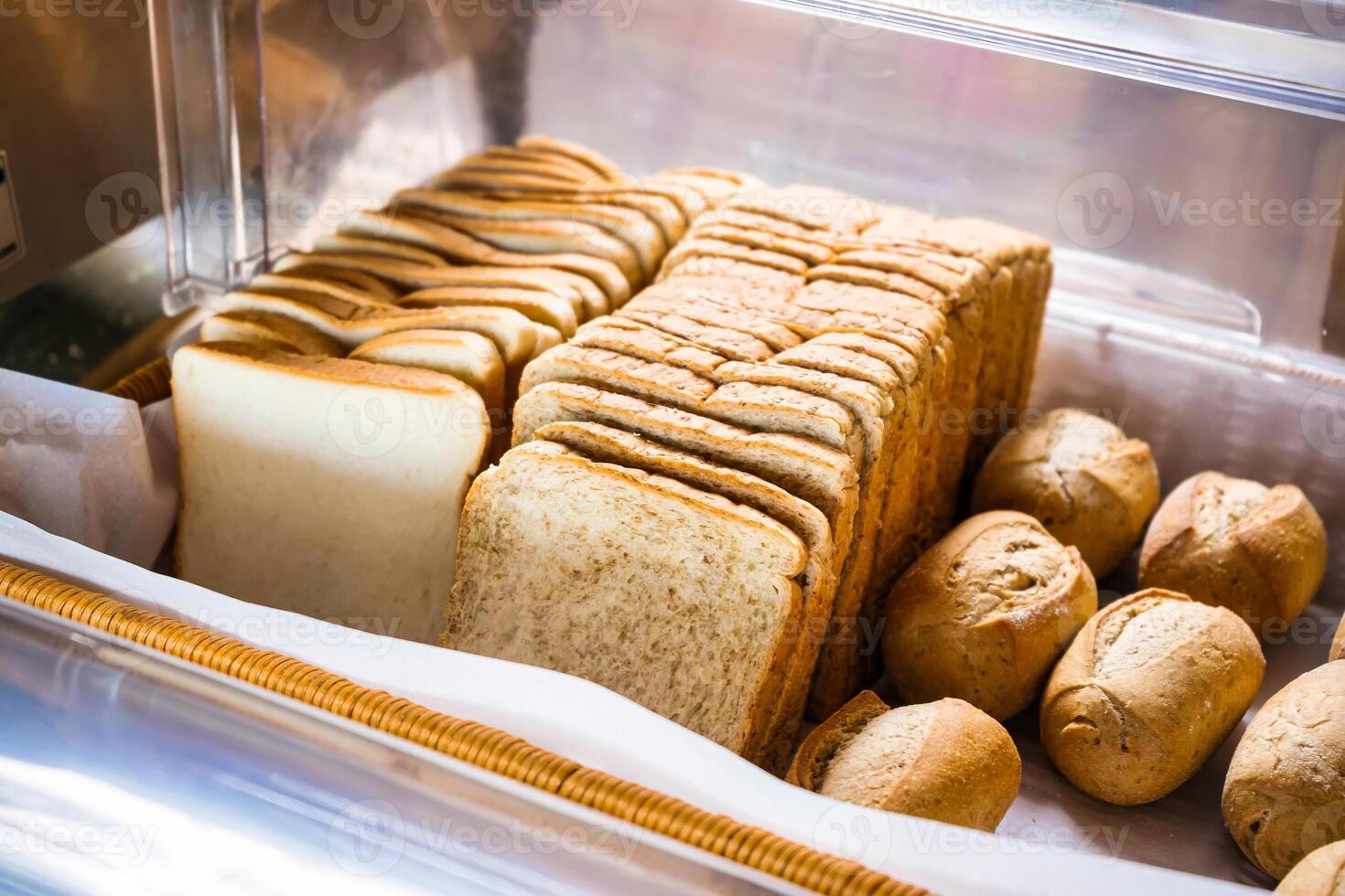 Delicious Freshly Baked Bread and Rolls in Bakery Display Case photo