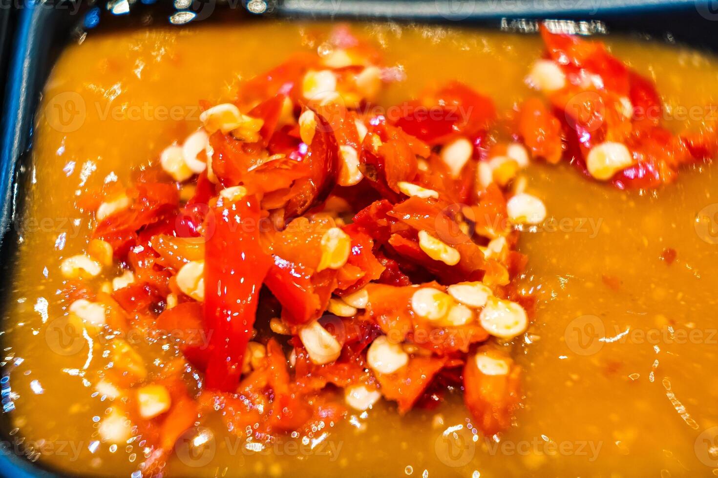 Close-Up of Freshly Chopped Red Chili Peppers in a Tangy Sauce - Perfect for Spicy Food Lovers photo