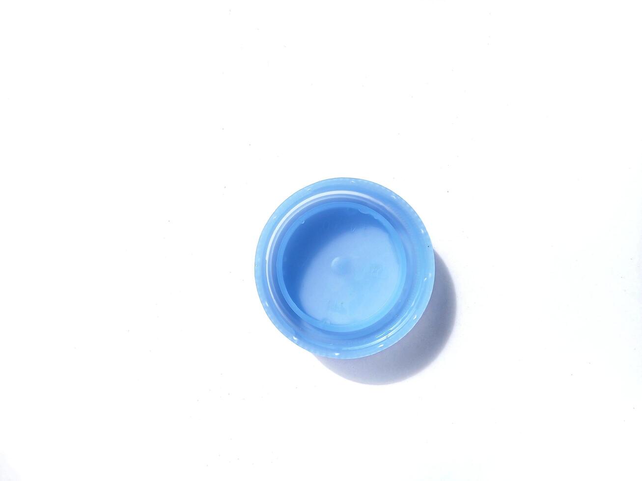 Blue water plastic caps for recycling isolated on white background. photo