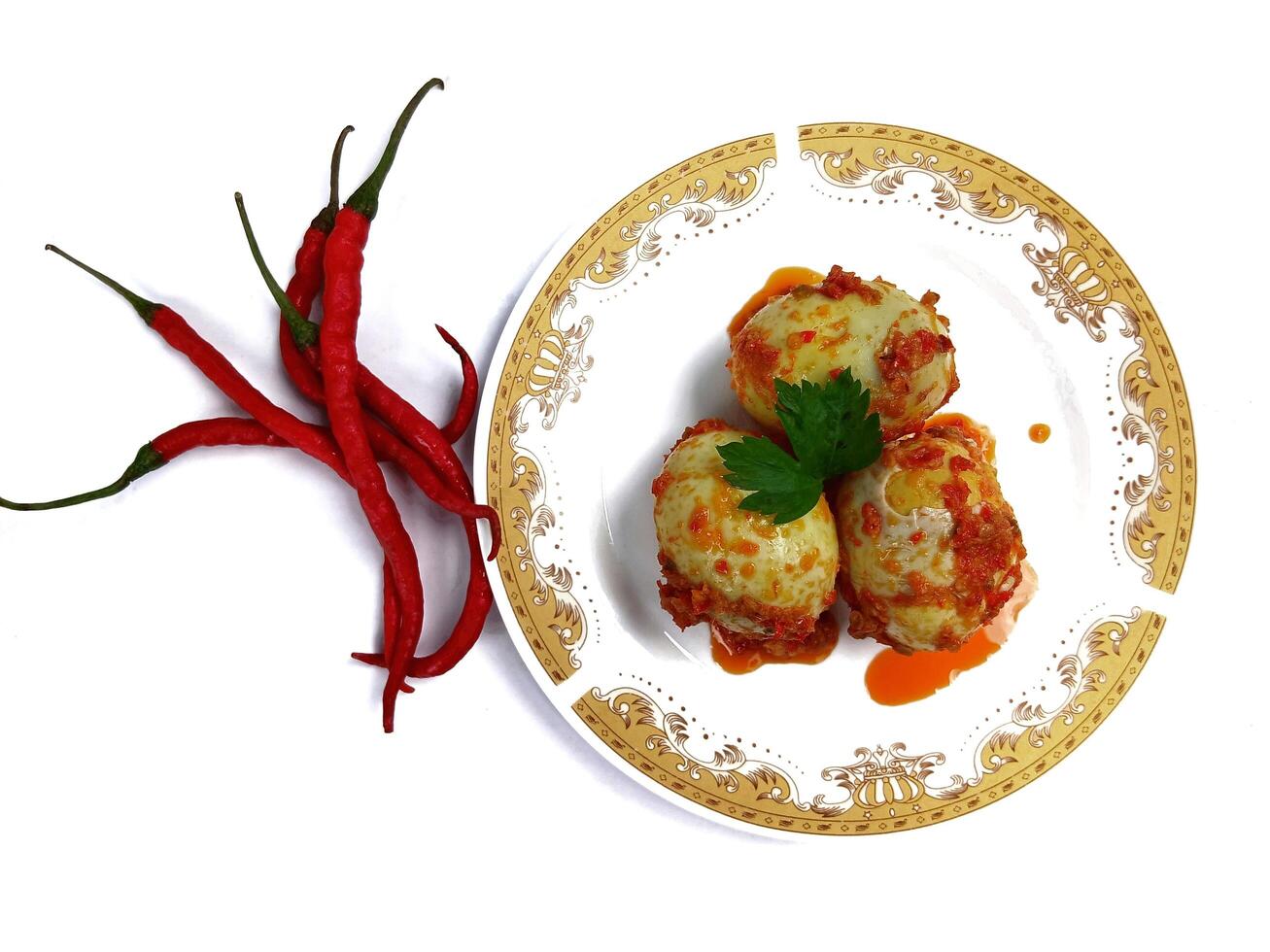 Egg Balado. Balado is a type of hot and spicy bumbu spice mixture found in Indonesian cuisine. Balado sauce is made by stir frying ground red hot chili pepper with other spices photo