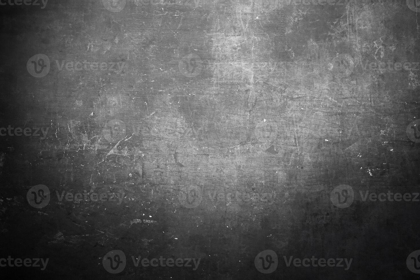 Dark textured surface with subtle scratches, specks, and grunge effect, ideal for backgrounds or design projects. photo