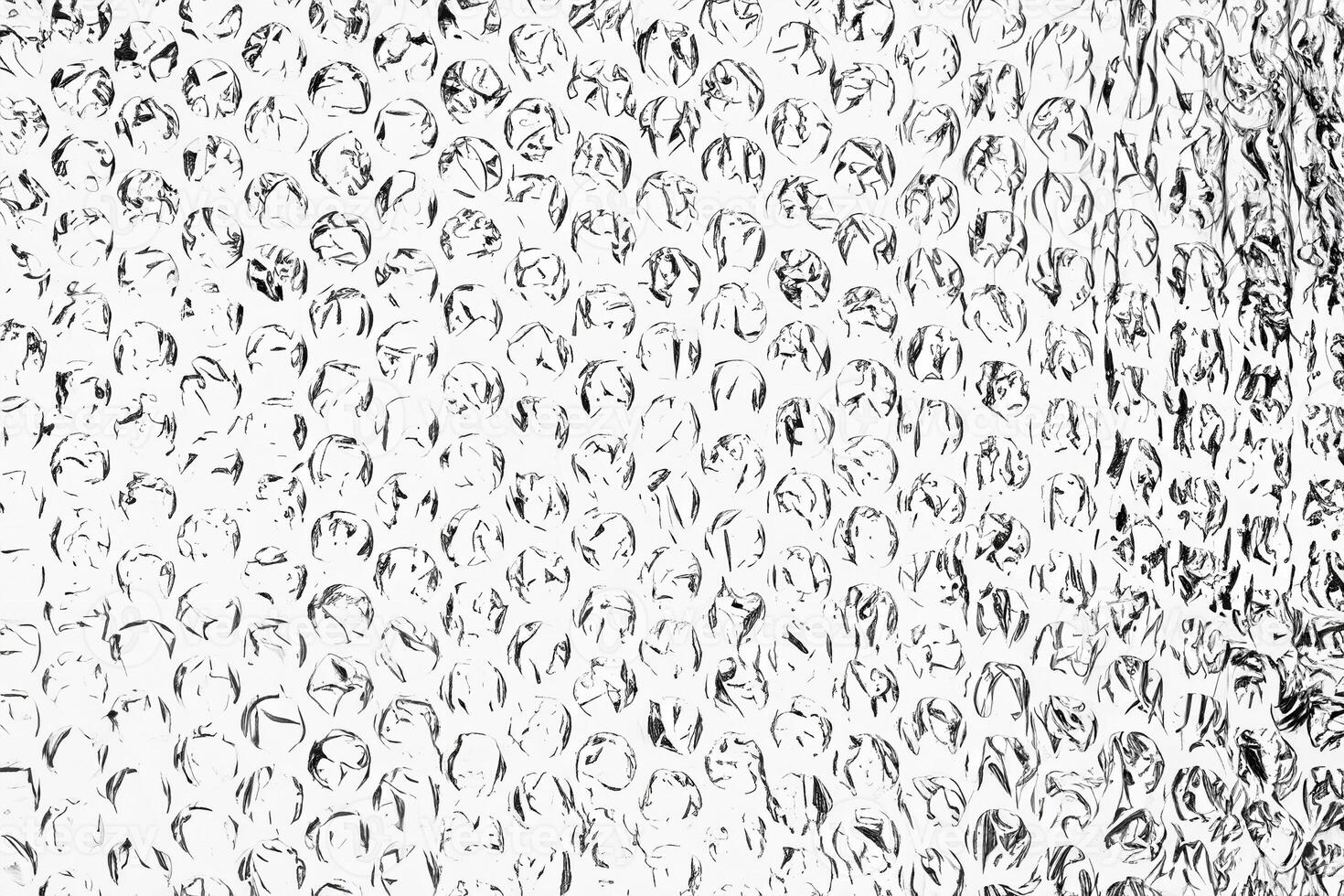 High contrast black and white bubble wrap texture with abstract circular patterns, perfect for creative backgrounds. photo