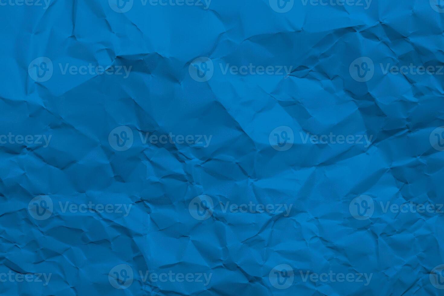 Abstract blue crumpled paper texture, ideal for creative backgrounds and graphic design. photo