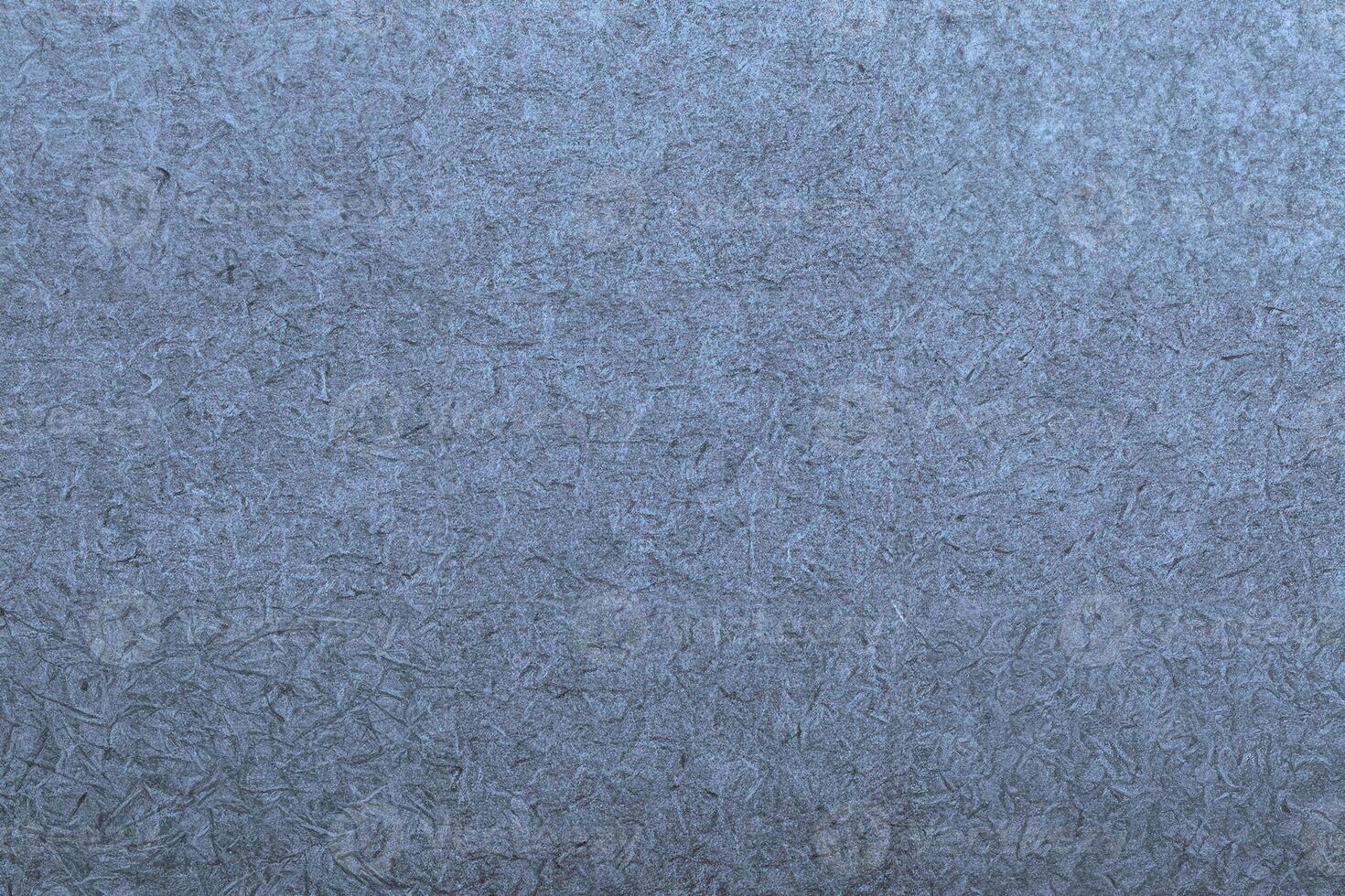 Gray textured paper background with fine fibers and subtle grain patterns, ideal for design or text overlays. photo