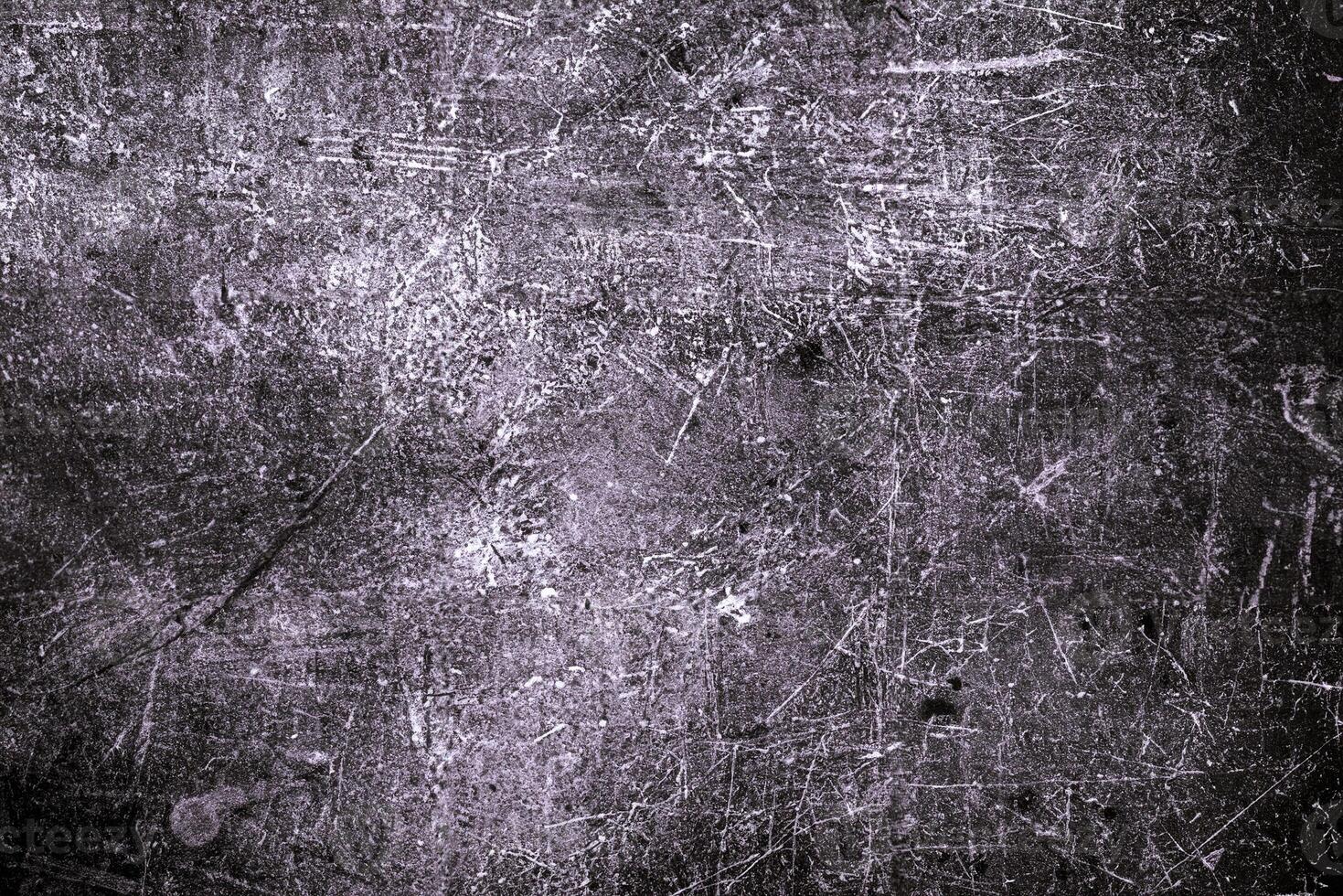 Rough dark grunge surface with prominent scratches and weathered details, perfect for edgy designs and backgrounds. photo