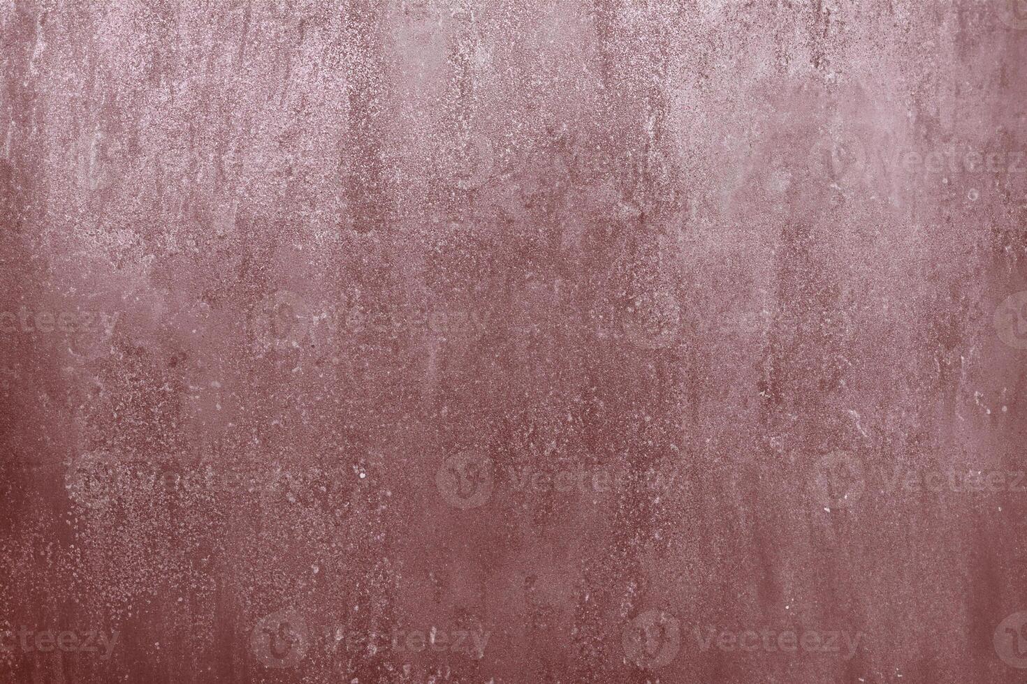 A close-up view of a rusty metal surface with a textured and weathered appearance in reddish-brown tones. photo