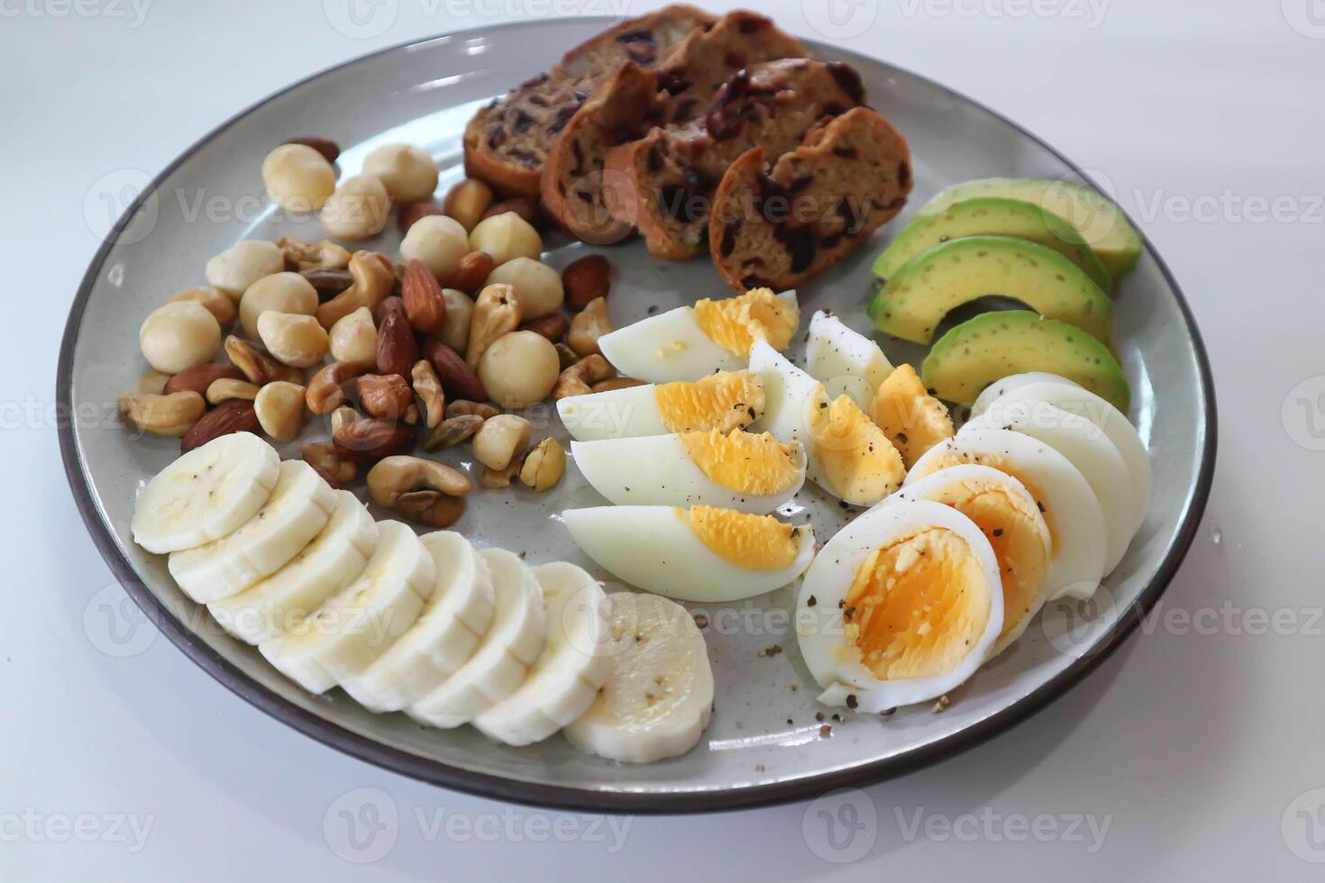 walnut cranberry sourdough bread or cranberry sourdough with boiled egg , avocado , banana and nuts photo